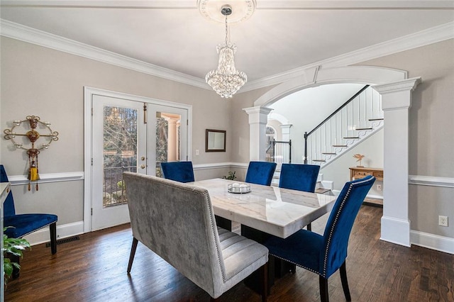 dining area with arched walkways, ornate columns, stairway, dark wood-style floors, and crown molding