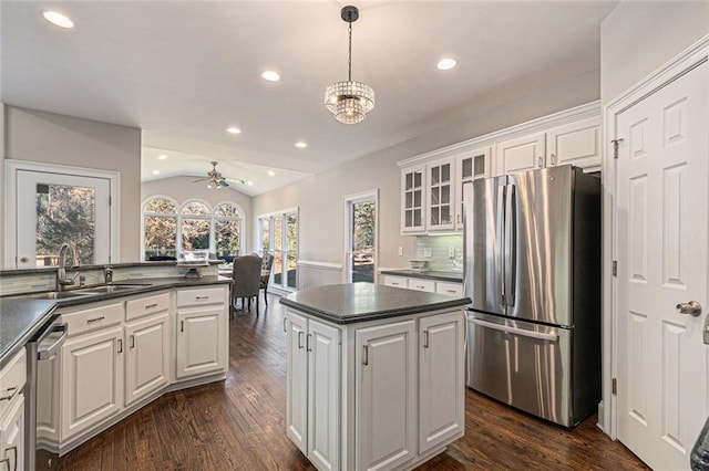 kitchen featuring stainless steel appliances, dark countertops, and white cabinets