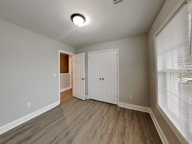 1232 Pinedale Cir NW, Conyers, GA 30012 - unfurnished bedroom with baseboards, wood finished floors, and a closet
