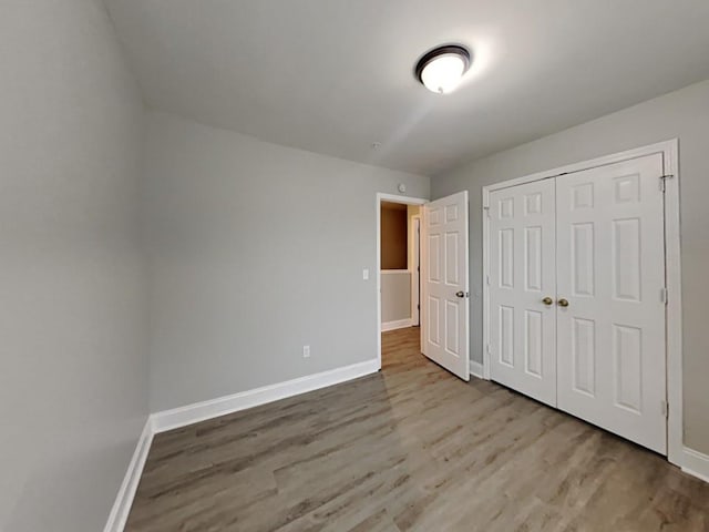 1232 Pinedale Cir NW, Conyers, GA 30012 - unfurnished bedroom with wood finished floors, baseboards, and a closet
