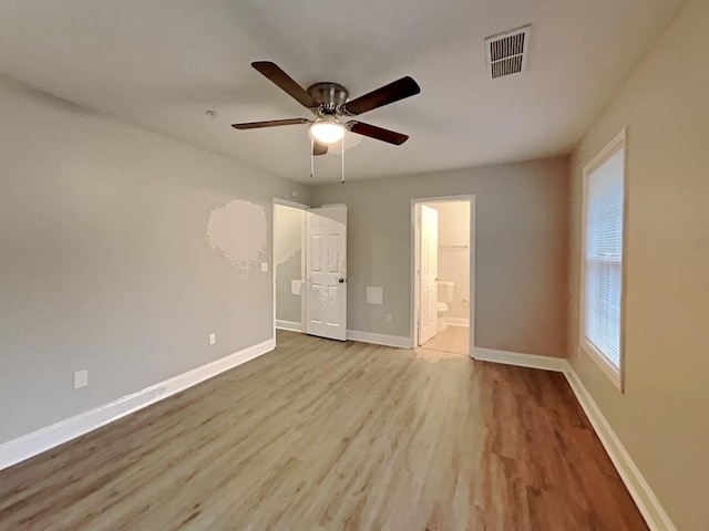 1232 Pinedale Cir NW, Conyers, GA 30012 - unfurnished bedroom with wood finished floors, baseboards, ensuite bathroom, and ceiling fan