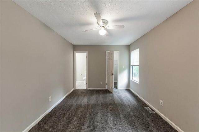 8541 Westchester Dr, Douglasville, GA 30134 - empty room featuring ceiling fan, dark colored carpet, baseboards, and a textured ceiling