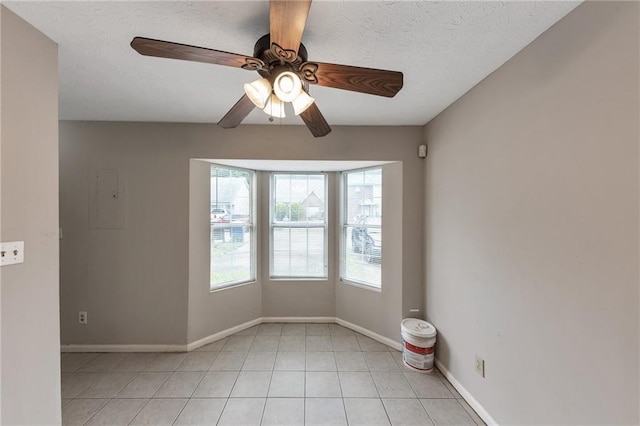 8541 Westchester Dr, Douglasville, GA 30134 - empty room with light tile patterned floors, ceiling fan, baseboards, and a textured ceiling