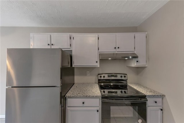 8541 Westchester Dr, Douglasville, GA 30134 - kitchen with black electric range, under cabinet range hood, freestanding refrigerator, white cabinets, and a textured ceiling