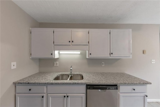 8541 Westchester Dr, Douglasville, GA 30134 - kitchen with stainless steel dishwasher, a sink, white cabinetry, and light stone counters