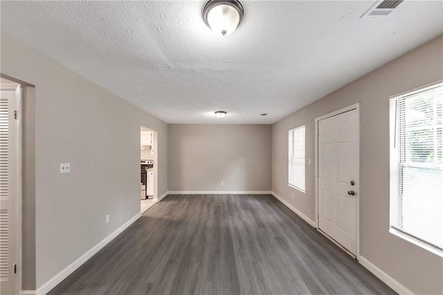 8541 Westchester Dr, Douglasville, GA 30134 - entrance foyer with dark wood-style flooring, baseboards, and a textured ceiling