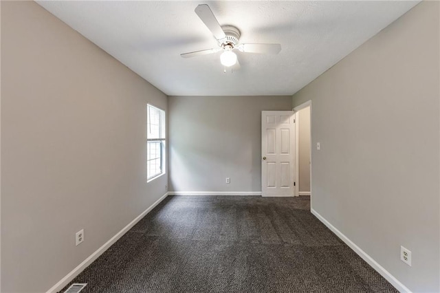 8541 Westchester Dr, Douglasville, GA 30134 - spare room with dark colored carpet, ceiling fan, and baseboards