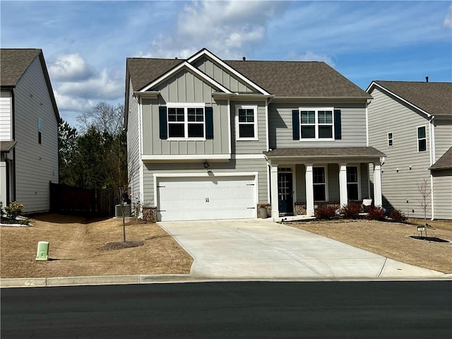 craftsman-style house with fence, covered porch, board and batten siding, concrete driveway, and a garage