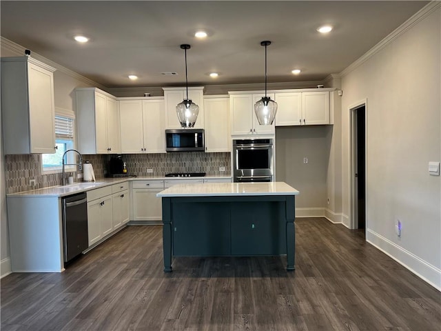 kitchen featuring white cabinets, appliances with stainless steel finishes, light countertops, and a sink