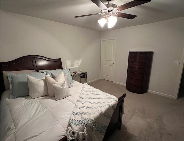 carpeted bedroom with baseboards and ceiling fan