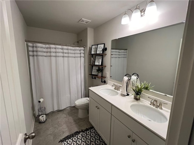 bathroom featuring a shower with curtain, vanity, tile patterned floors, and toilet