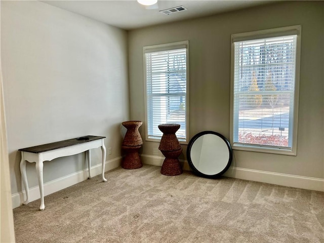 sitting room featuring visible vents, baseboards, and carpet