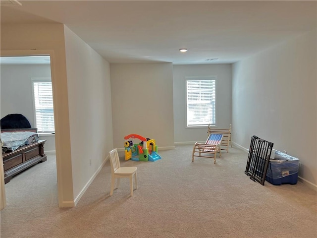 rec room featuring a wealth of natural light, baseboards, and carpet