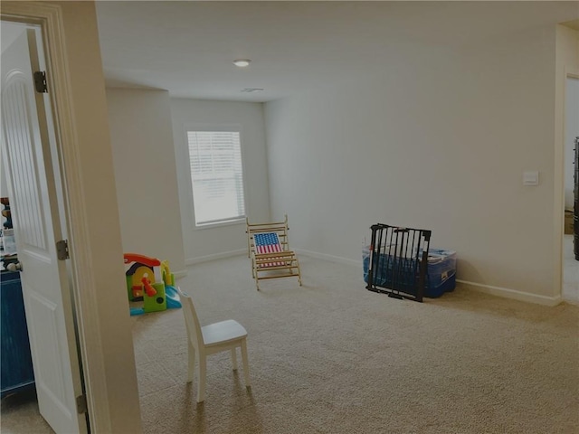 rec room featuring baseboards and carpet floors