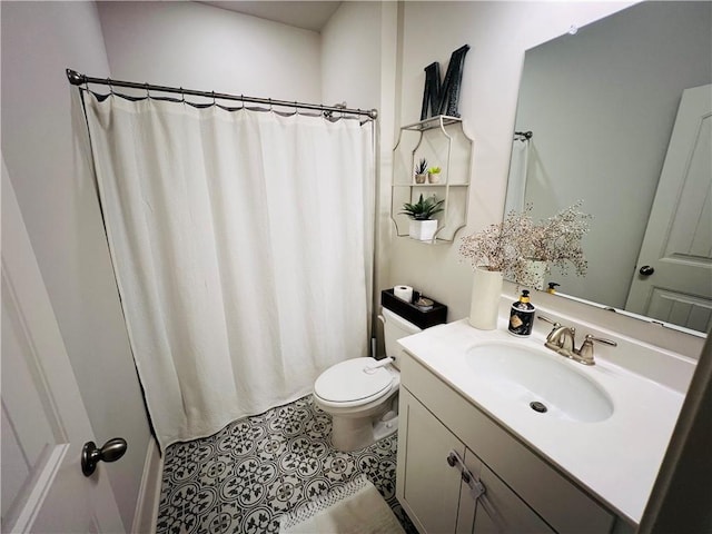 bathroom with tile patterned flooring, vanity, and toilet