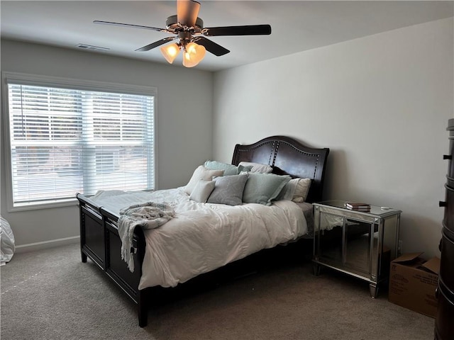 carpeted bedroom featuring visible vents, baseboards, and a ceiling fan