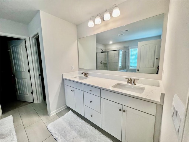 full bath featuring double vanity, tile patterned flooring, a shower stall, and a sink