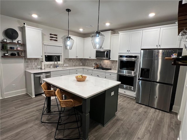 kitchen featuring white cabinetry, appliances with stainless steel finishes, and a center island