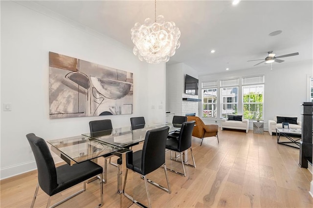 343 Concord St, Alpharetta, GA 30009 - dining area featuring a brick fireplace, light wood-style flooring, a chandelier, recessed lighting, and baseboards