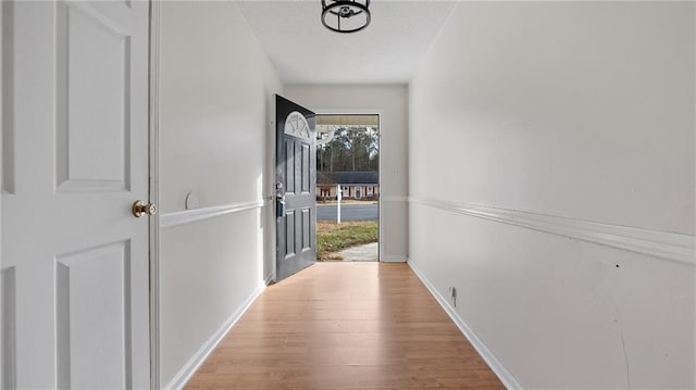 corridor with light hardwood / wood-style floors