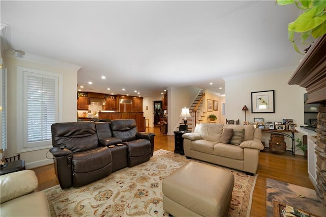 living room with crown molding and light hardwood / wood-style flooring