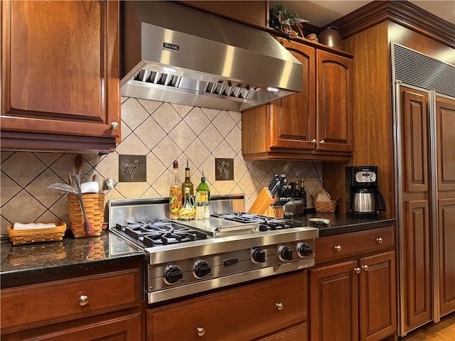 kitchen with tasteful backsplash, extractor fan, and stainless steel gas cooktop