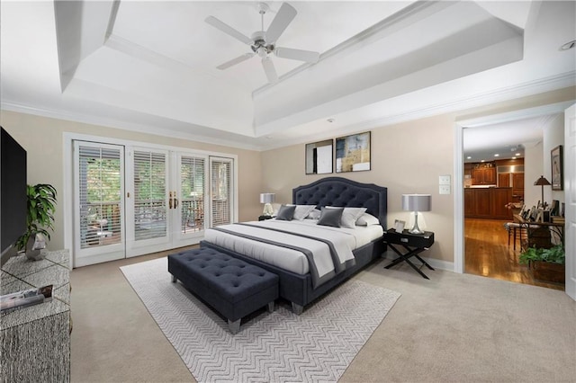 carpeted bedroom featuring a raised ceiling, crown molding, access to exterior, and french doors