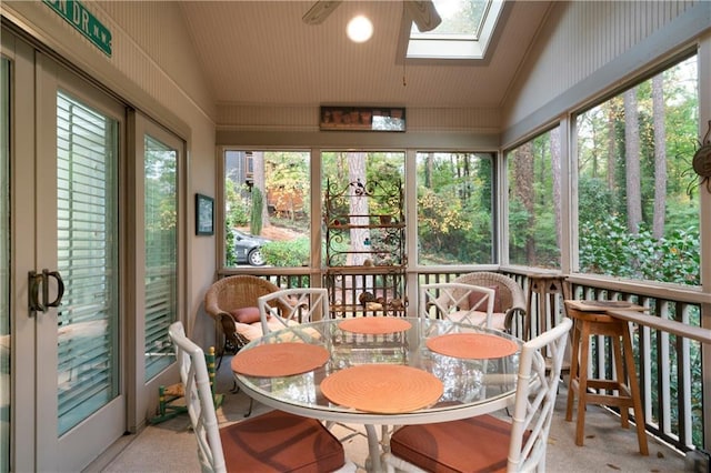 sunroom / solarium with lofted ceiling with skylight