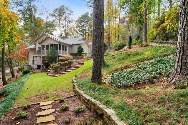 view of yard featuring a sunroom