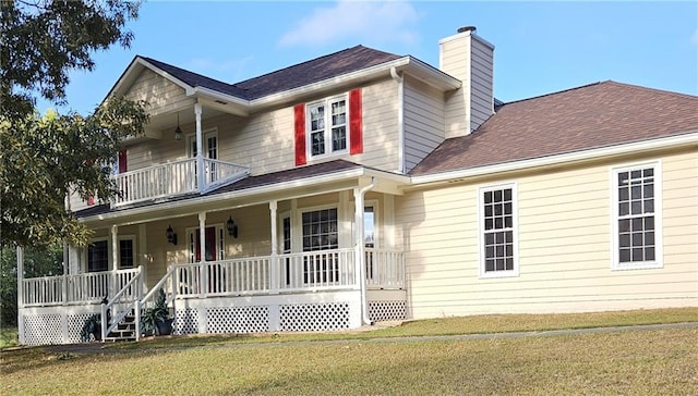 view of front of house featuring a front yard, covered porch, and a balcony