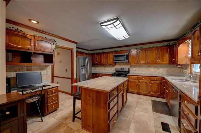 kitchen with stainless steel appliances, crown molding, decorative backsplash, a kitchen island, and sink