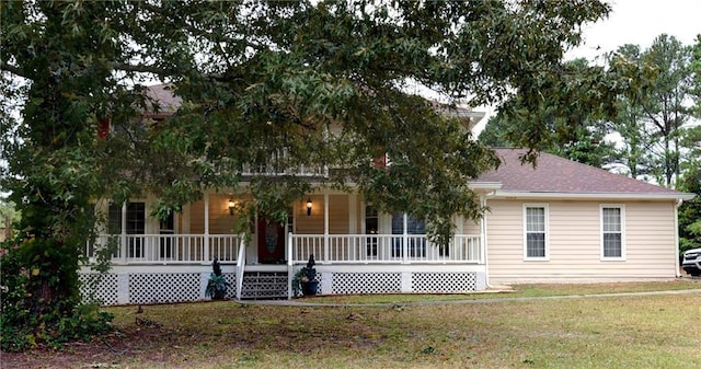 view of front of property with a front yard and covered porch