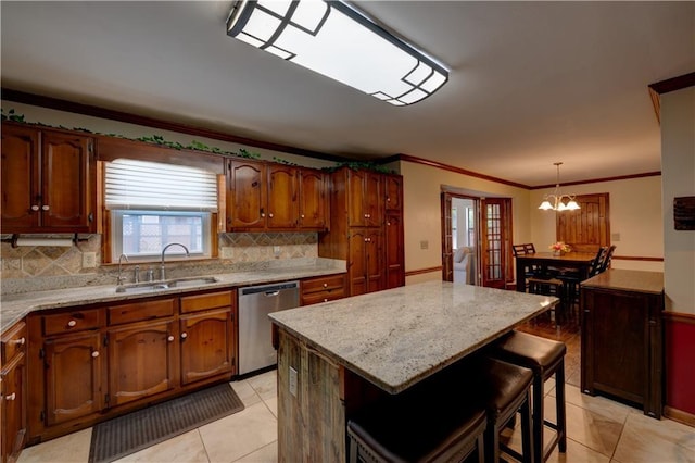 kitchen featuring hanging light fixtures, a center island, sink, stainless steel dishwasher, and light tile patterned flooring