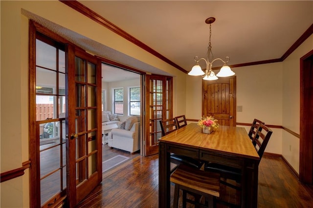 dining area featuring ornamental molding, french doors, a chandelier, and dark hardwood / wood-style floors