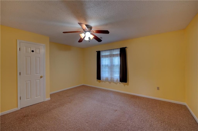 empty room with a textured ceiling, ceiling fan, and carpet flooring