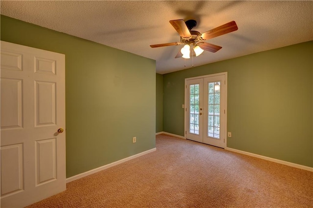 spare room featuring a textured ceiling, ceiling fan, french doors, and carpet flooring