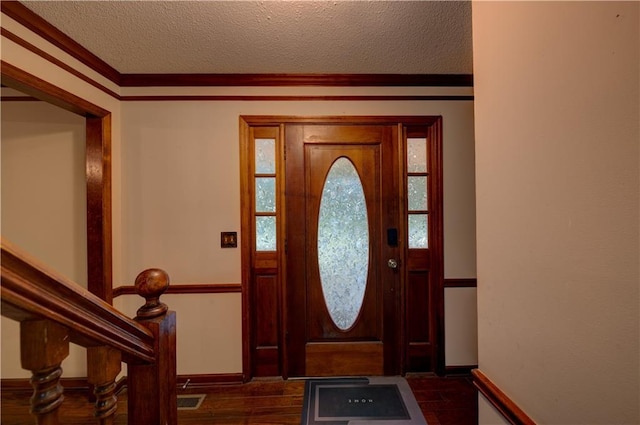 entryway with dark wood-type flooring and a textured ceiling