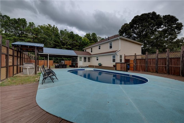 view of swimming pool with a jacuzzi and a wooden deck