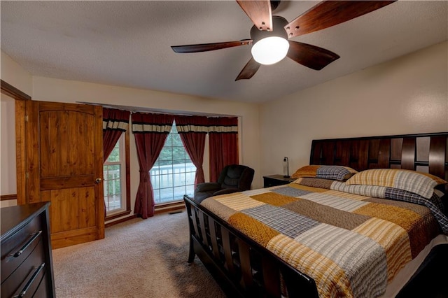 bedroom featuring light colored carpet, ceiling fan, and access to exterior