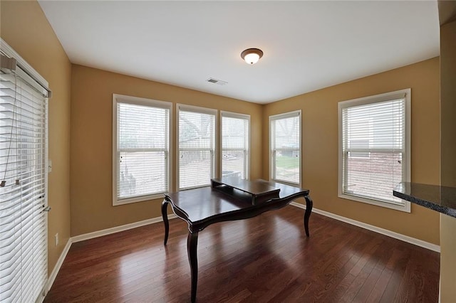 unfurnished office with dark hardwood / wood-style flooring