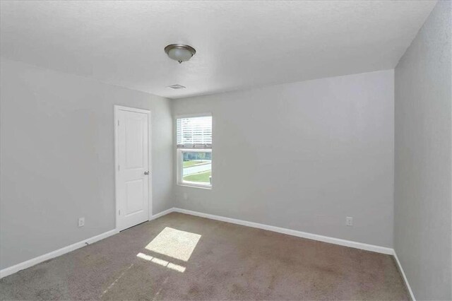 empty room featuring carpet flooring