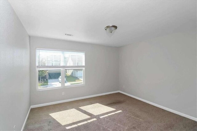 unfurnished room with carpet flooring