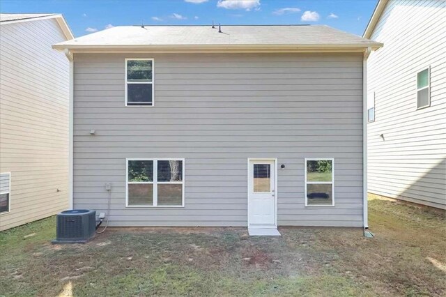 rear view of house featuring central AC