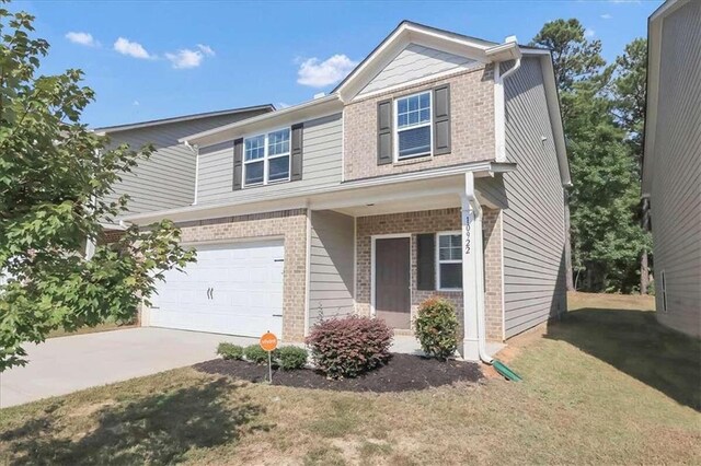 view of front of house with a garage and a front yard