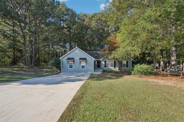 view of front of house with a front lawn and concrete driveway