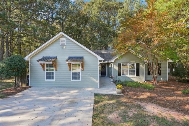 view of front facade with driveway and brick siding