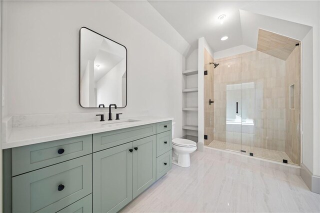 full bathroom featuring vanity, vaulted ceiling, toilet, a stall shower, and built in features