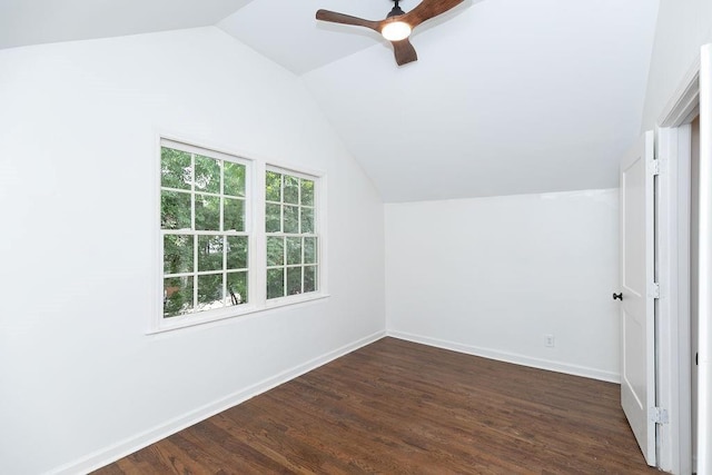 bonus room with baseboards, ceiling fan, vaulted ceiling, and dark wood-style flooring
