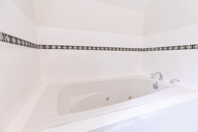full bathroom featuring a tub with jets