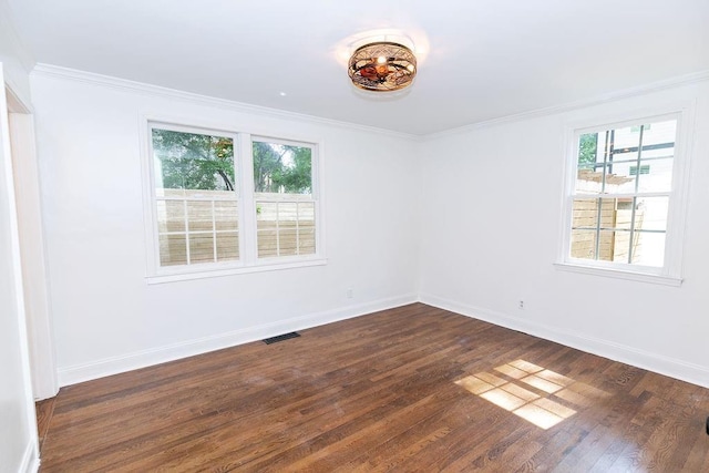 unfurnished room with baseboards, ornamental molding, and dark wood-style flooring